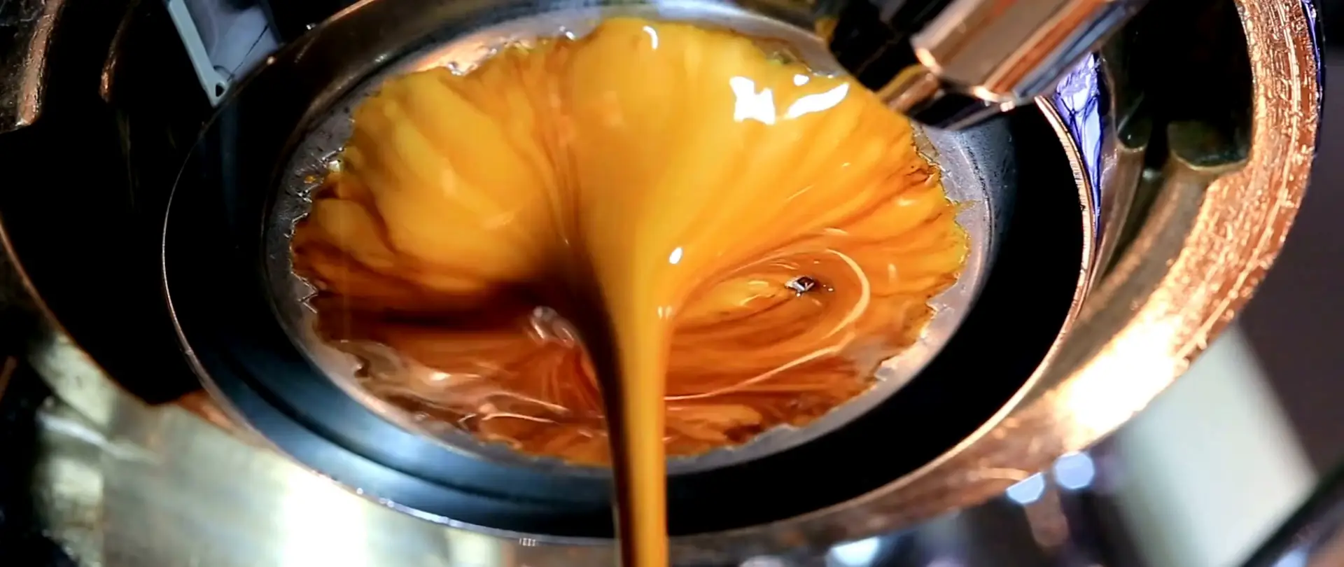 Espresso pouring from a bottomless portafilter in the KIKI Coffee van