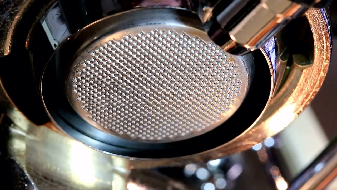 Close-up of a KIKI Coffee portafilter basket on the espresso machine